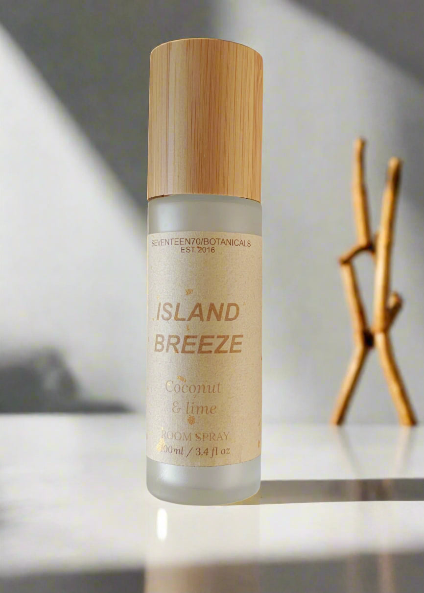 Deodorant spray bottle labeled 'Island Breeze' with a wooden cap on a white background