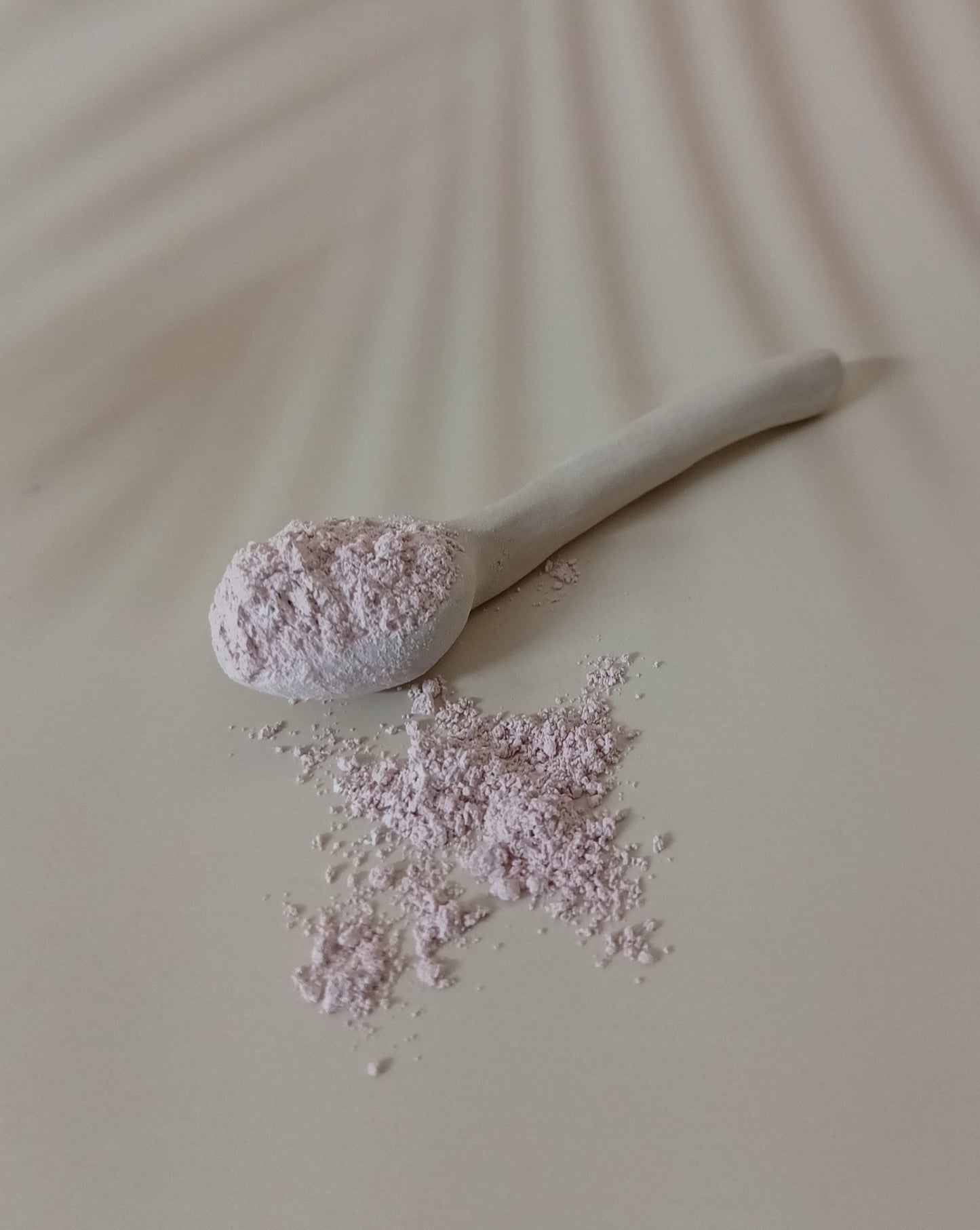 hydrating clay powder on a spoon