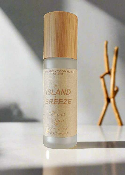Deodorant spray bottle labeled 'Island Breeze' with a wooden cap on a white background