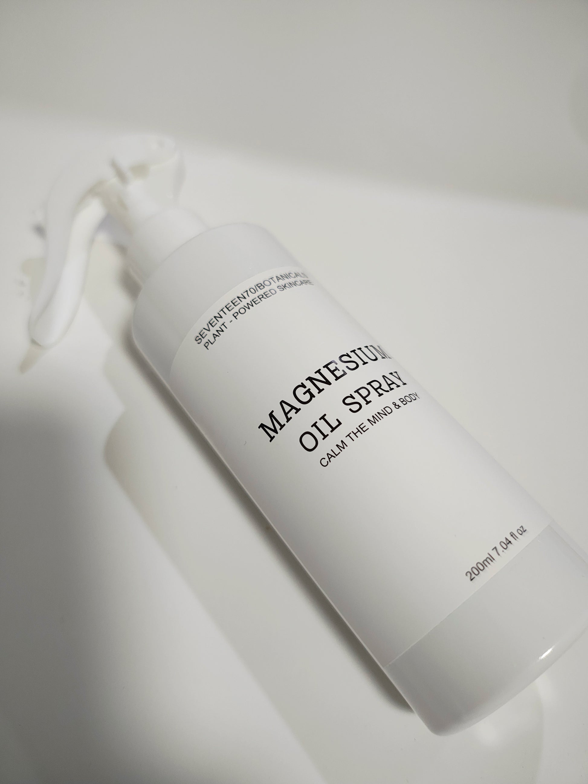 Magnesium oil spray bottle on a white background